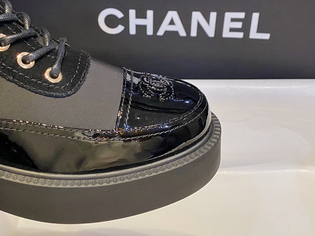 Chanel Martin Boots: The Patent Leather Toe Instantly Adds Refinement to the Overall Look. 