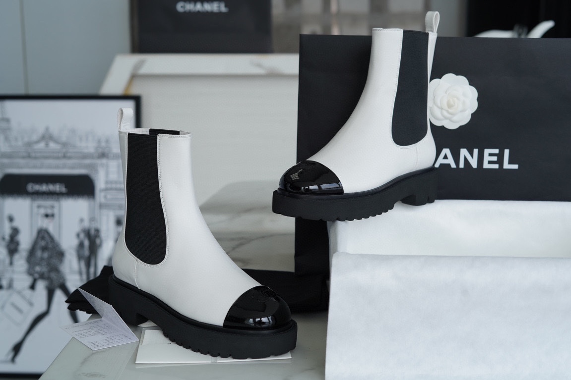 Chanel 22c Chunky Black and White Spliced Slip-On Short Boots: Featuring Rich Texture Inside and Out, with Delicate Sheepskin and Glossy Patent Leather. Exuding Understated Sophistication