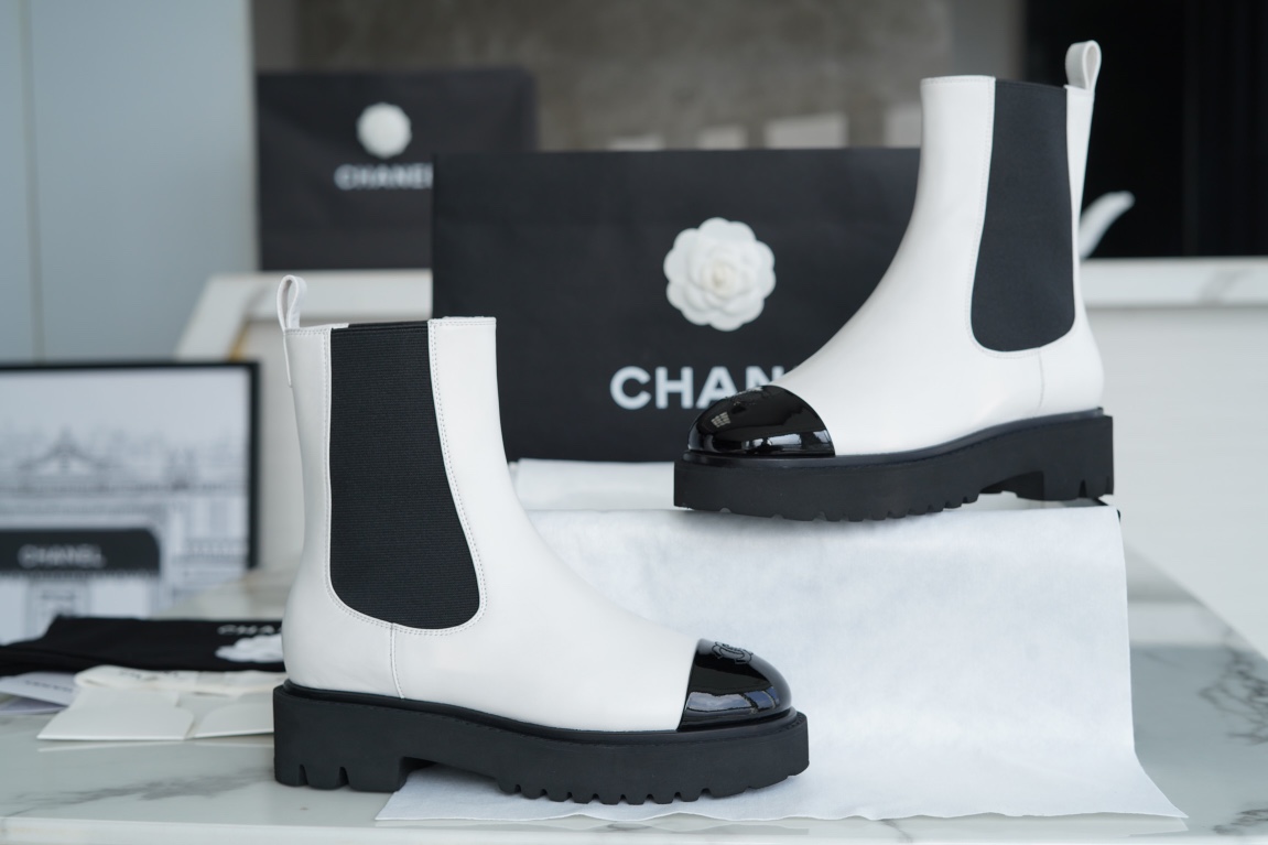 Chanel 22c Chunky Black and White Spliced Slip-On Short Boots: Featuring Rich Texture Inside and Out, with Delicate Sheepskin and Glossy Patent Leather. Exuding Understated Sophistication