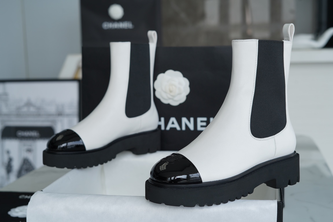 Chanel 22c Chunky Black and White Spliced Slip-On Short Boots: Featuring Rich Texture Inside and Out, with Delicate Sheepskin and Glossy Patent Leather. Exuding Understated Sophistication