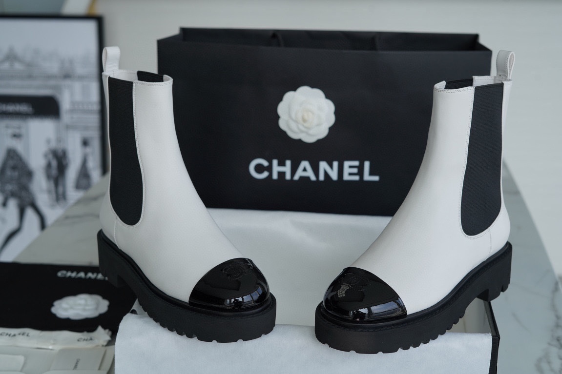 Chanel 22c Chunky Black and White Spliced Slip-On Short Boots: Featuring Rich Texture Inside and Out, with Delicate Sheepskin and Glossy Patent Leather. Exuding Understated Sophistication