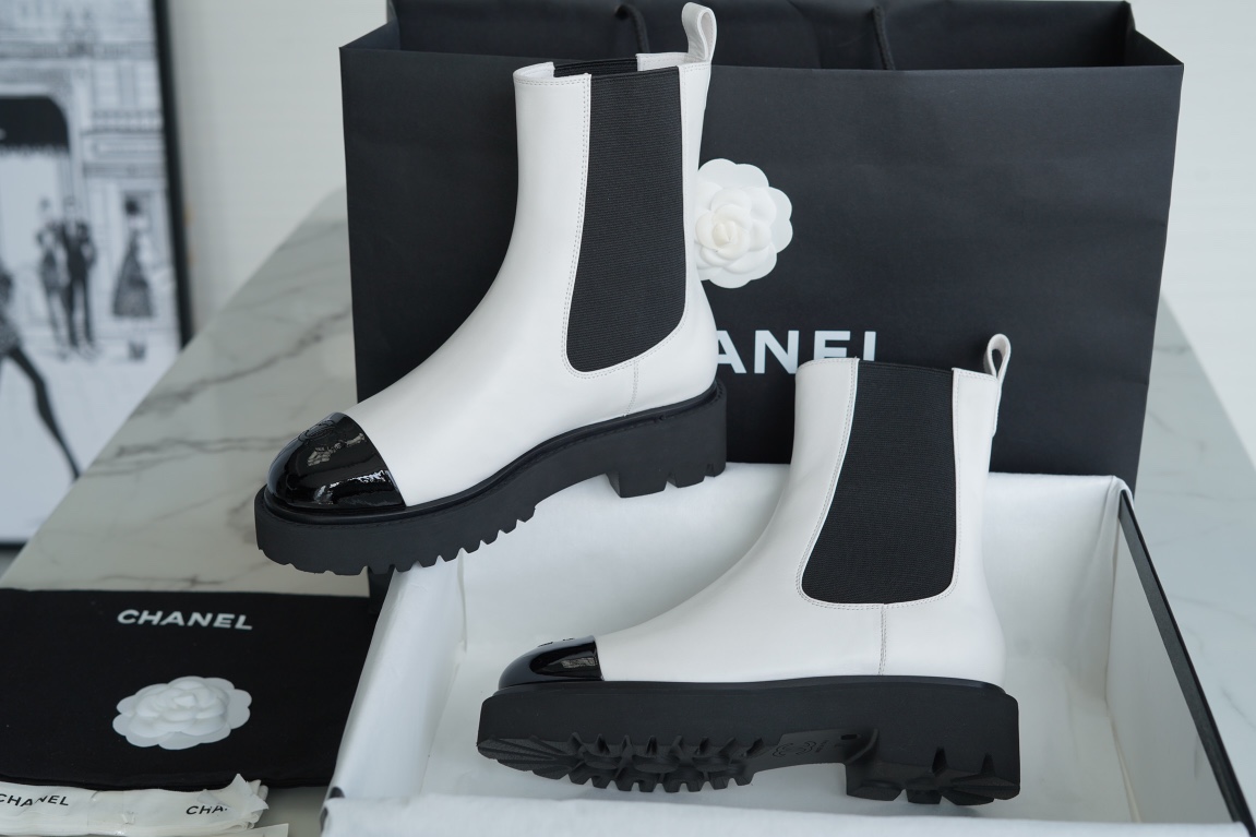 Chanel 22c Chunky Black and White Spliced Slip-On Short Boots: Featuring Rich Texture Inside and Out, with Delicate Sheepskin and Glossy Patent Leather. Exuding Understated Sophistication