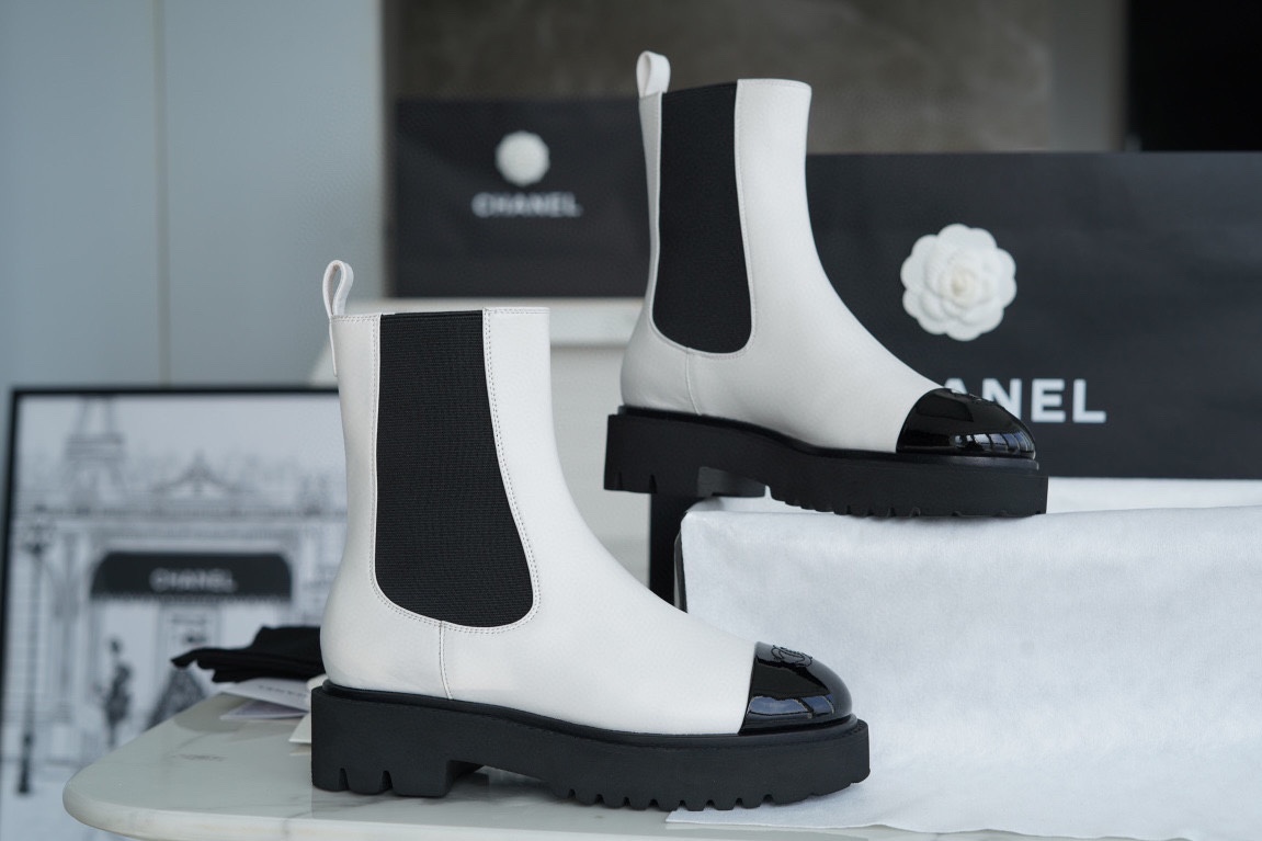 Chanel 22c Chunky Black and White Spliced Slip-On Short Boots: Featuring Rich Texture Inside and Out, with Delicate Sheepskin and Glossy Patent Leather. Exuding Understated Sophistication