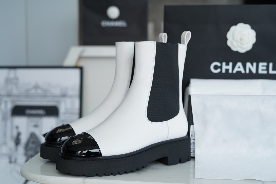 Chanel 22c Chunky Black and White Spliced Slip-On Short Boots: Featuring Rich Texture Inside and Out, with Delicate Sheepskin and Glossy Patent Leather. Exuding Understated Sophistication