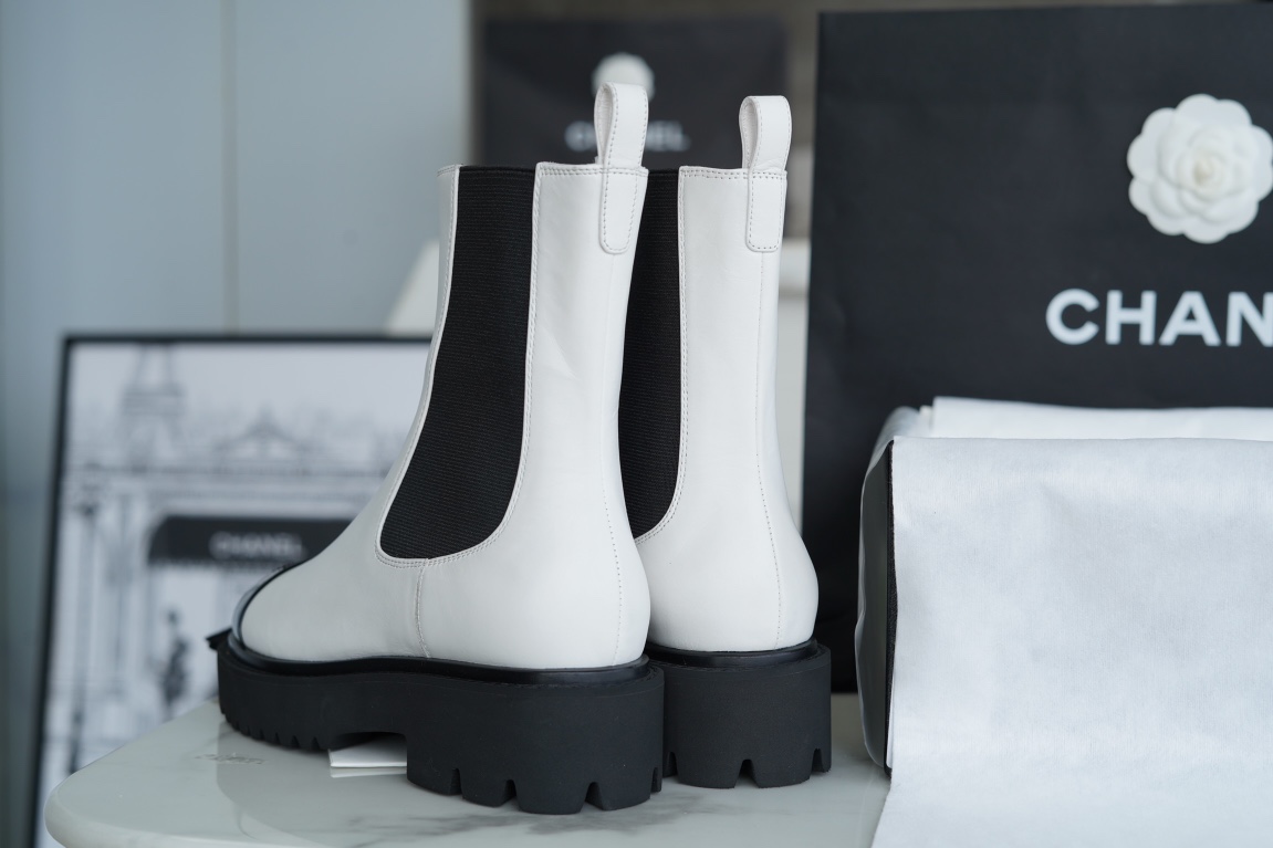 Chanel 22c Chunky Black and White Spliced Slip-On Short Boots: Featuring Rich Texture Inside and Out, with Delicate Sheepskin and Glossy Patent Leather. Exuding Understated Sophistication