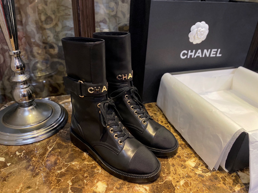 Chanel  Letter Logo Lace-Up Boots: A pair of classic and fashionable long boots with a unique and elegant design