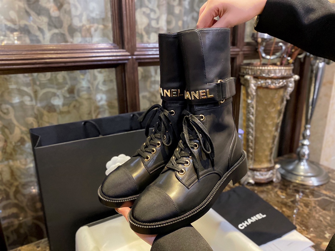 Chanel  Letter Logo Lace-Up Boots: A pair of classic and fashionable long boots with a unique and elegant design