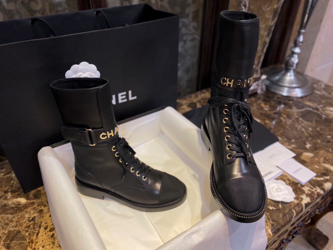 Chanel  Letter Logo Lace-Up Boots: A pair of classic and fashionable long boots with a unique and elegant design