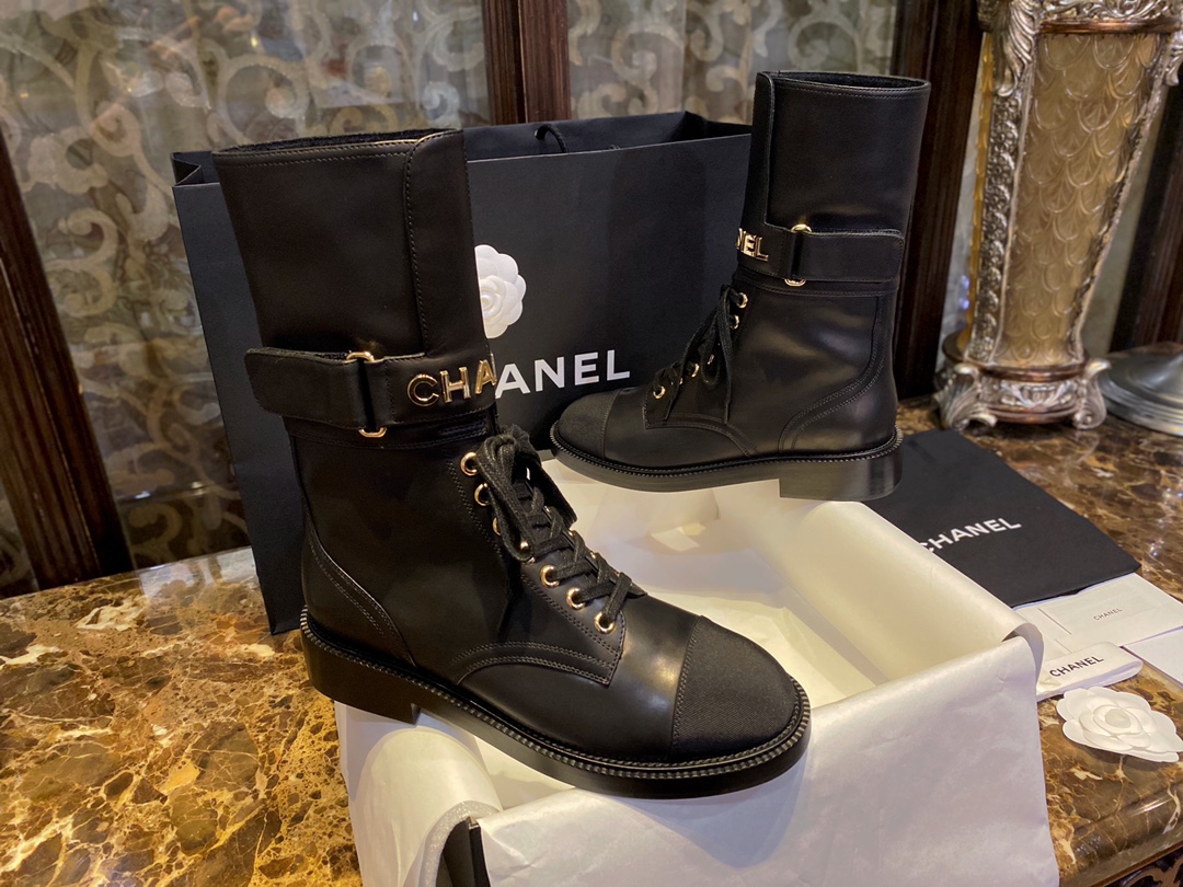 Chanel  Letter Logo Lace-Up Boots: A pair of classic and fashionable long boots with a unique and elegant design