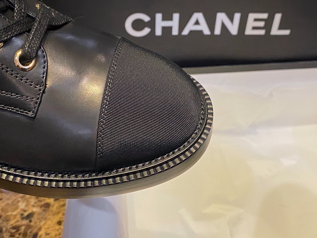 Chanel  Letter Logo Lace-Up Boots: A pair of classic and fashionable long boots with a unique and elegant design