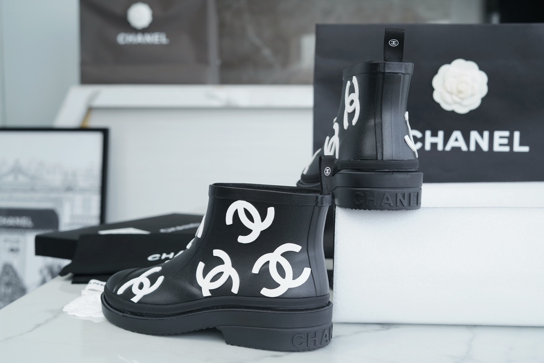 Chanel 23a Black Double C Full Logo Short Rain Boots: Made with Environmentally Friendly Lightweight Rubber Imported from Italy, Inner Fabric Lining Provides Softness, Giving a Feeling of Walking on Clouds. The Displaced Distribution of Logos Instantly El