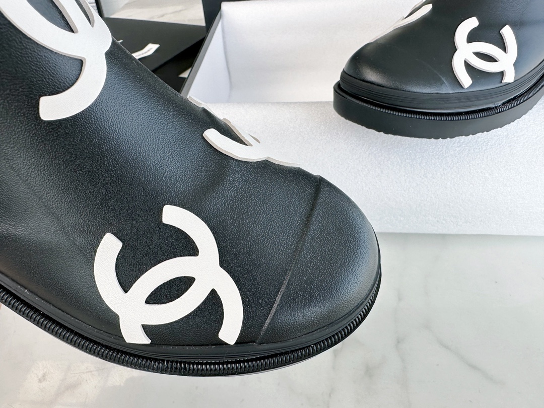 Chanel 23a Black Double C Full Logo Short Rain Boots: Made with Environmentally Friendly Lightweight Rubber Imported from Italy, Inner Fabric Lining Provides Softness, Giving a Feeling of Walking on Clouds. The Displaced Distribution of Logos Instantly El