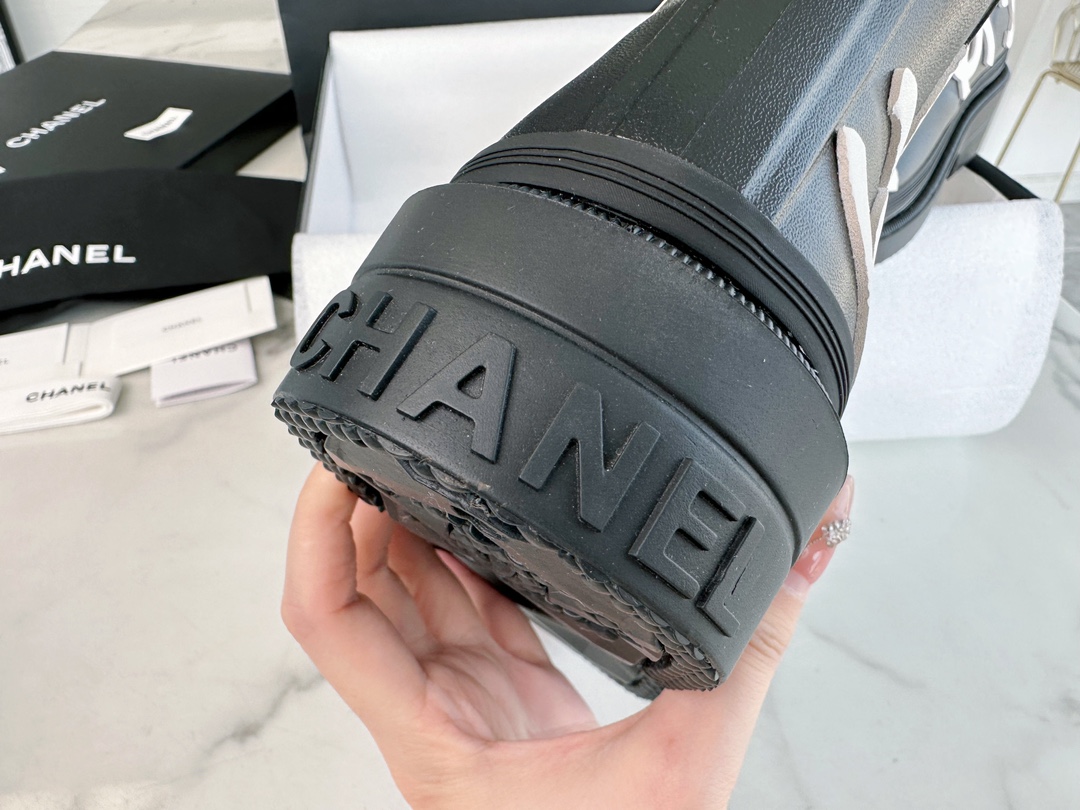 Chanel 23a Black Double C Full Logo Short Rain Boots: Made with Environmentally Friendly Lightweight Rubber Imported from Italy, Inner Fabric Lining Provides Softness, Giving a Feeling of Walking on Clouds. The Displaced Distribution of Logos Instantly El