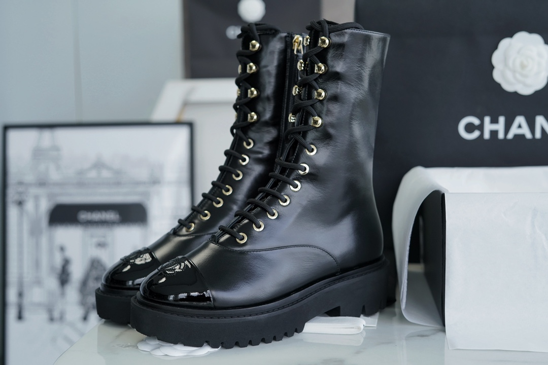 Chanel 23C Black Lace-Up Martin Boots: Crafted with sleek calfskin and patent leather