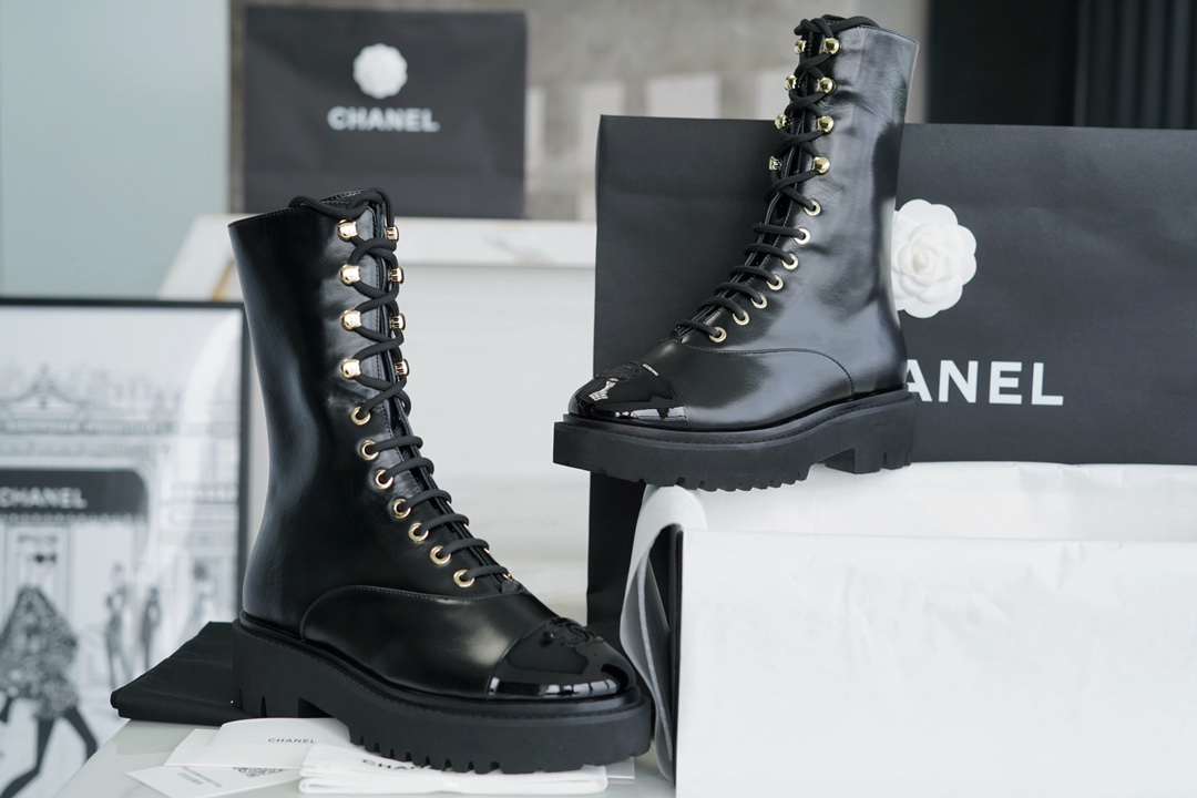 Chanel 23C Black Lace-Up Martin Boots: Crafted with sleek calfskin and patent leather