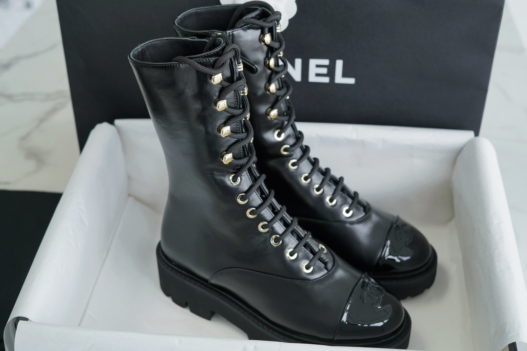 Chanel 23C Black Lace-Up Martin Boots: Crafted with sleek calfskin and patent leather