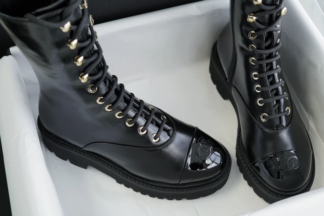 Chanel 23C Black Lace-Up Martin Boots: Crafted with sleek calfskin and patent leather