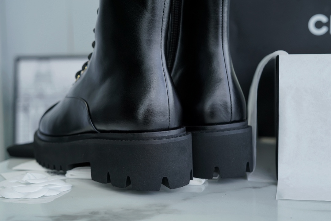 Chanel 23C Black Lace-Up Martin Boots: Crafted with sleek calfskin and patent leather