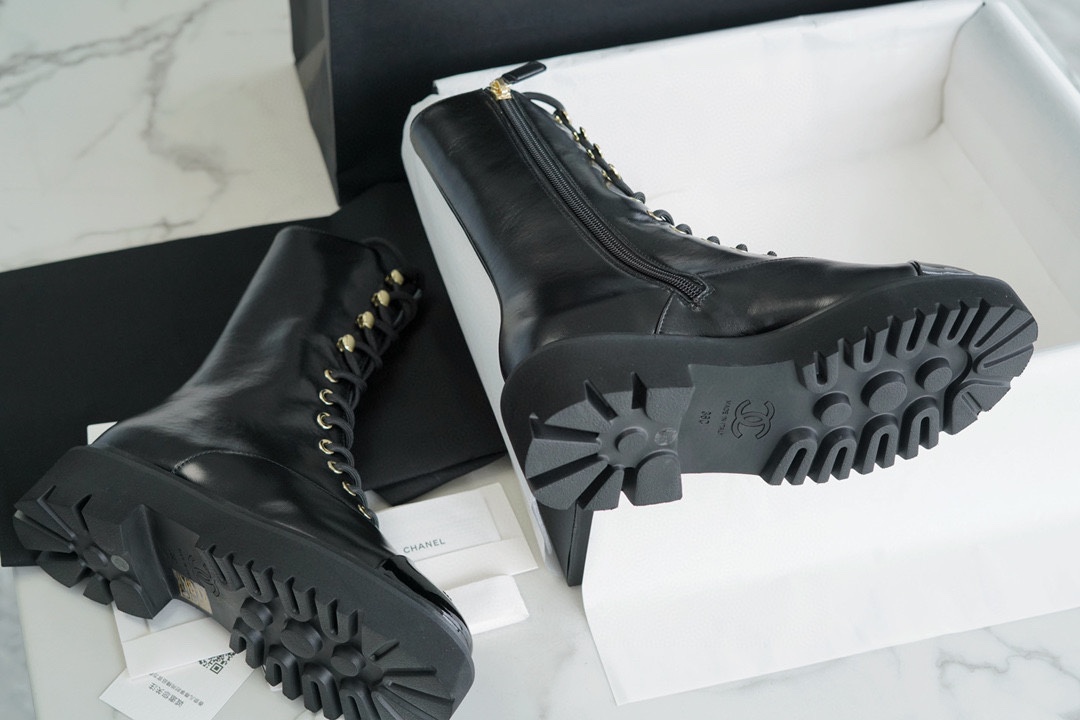 Chanel 23C Black Lace-Up Martin Boots: Crafted with sleek calfskin and patent leather