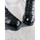 Chanel  23b  Chain Long Martin Boots: Crafted from black oil leather and black patent leather, with a leather combination sole. Classic diamond-pattern stitching and chain elements intertwine on the vamp