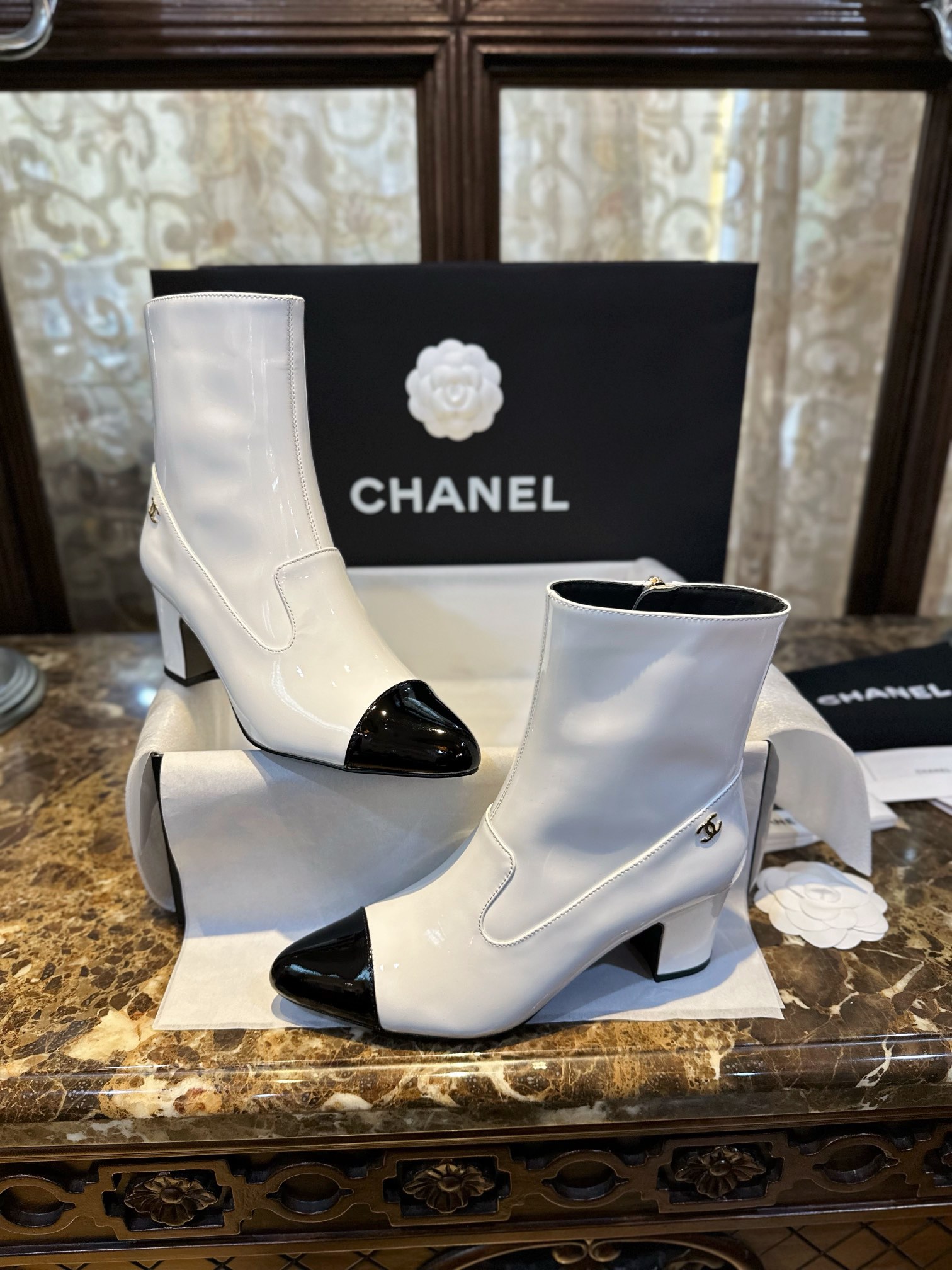 Chanel  23b  Featuring classic black and white contrast with glossy cowhide leather