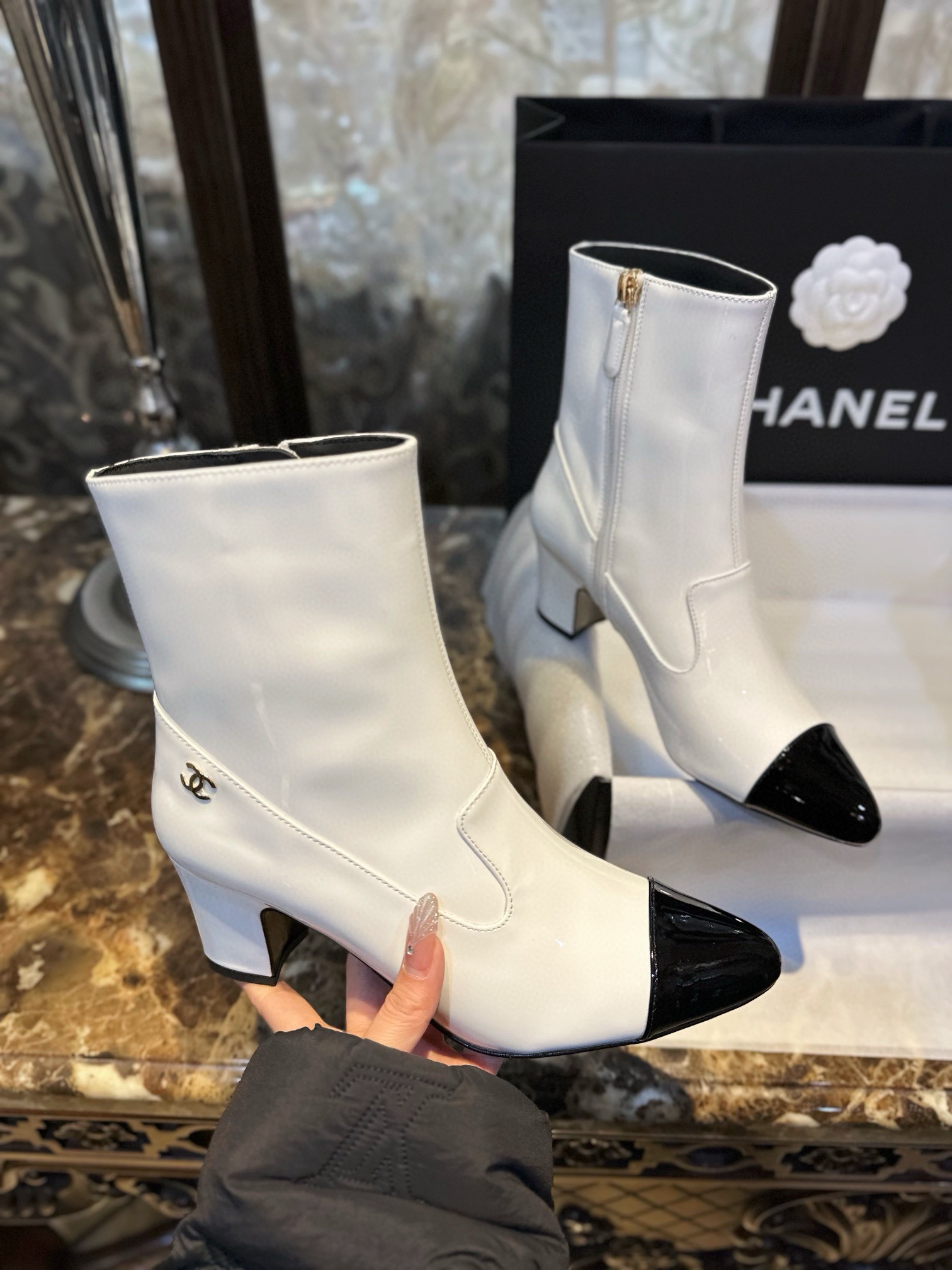 Chanel  23b  Featuring classic black and white contrast with glossy cowhide leather