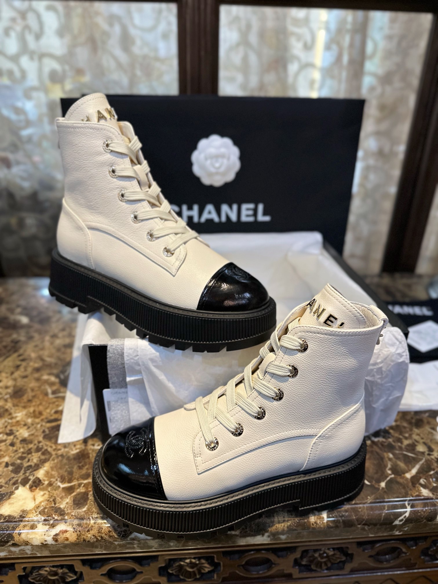 Chanel  23b Chunky Sole Martin Ankle Boots: Featuring a combination of white lychee-patterned cowhide and black oil-wax leather