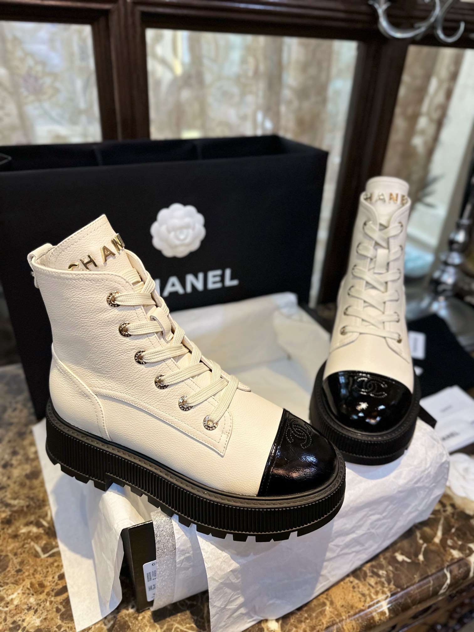 Chanel  23b Chunky Sole Martin Ankle Boots: Featuring a combination of white lychee-patterned cowhide and black oil-wax leather