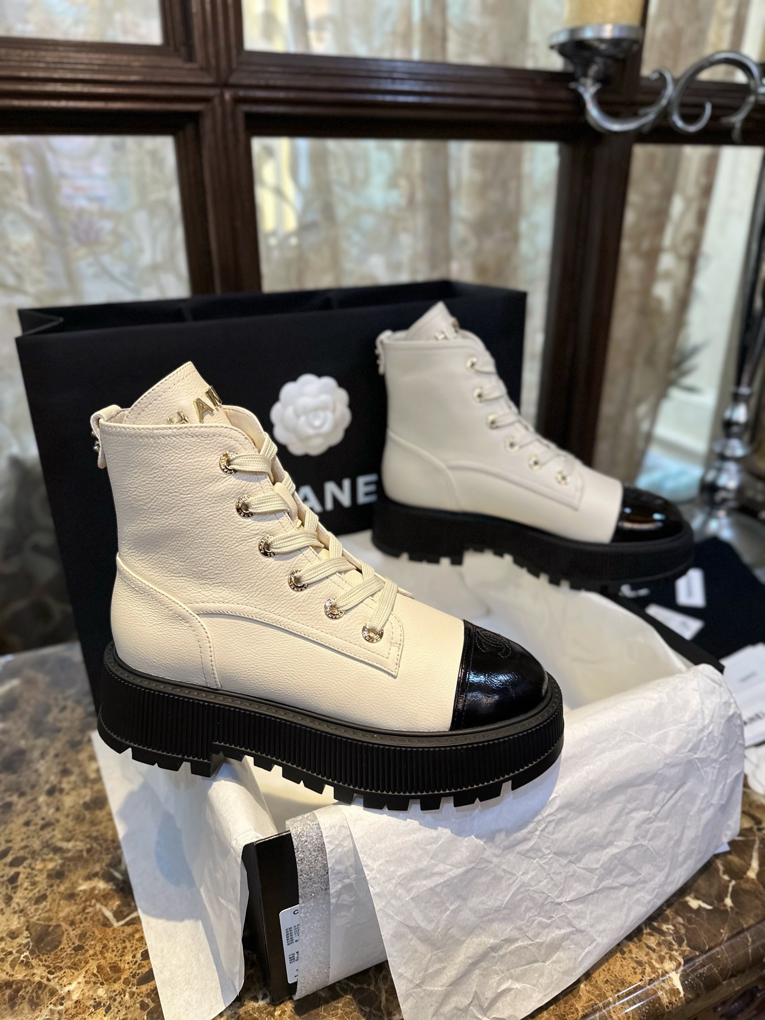 Chanel  23b Chunky Sole Martin Ankle Boots: Featuring a combination of white lychee-patterned cowhide and black oil-wax leather