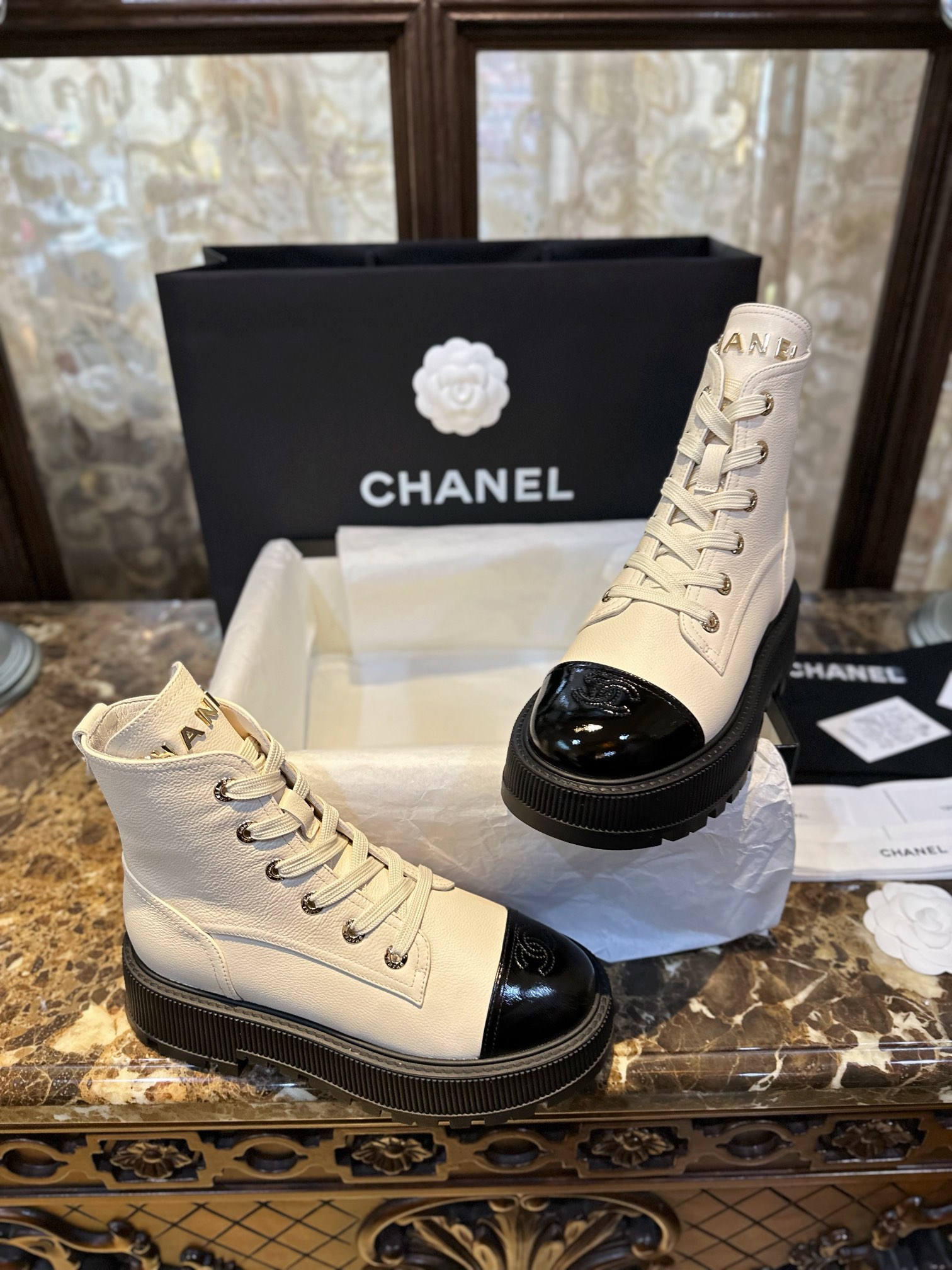 Chanel  23b Chunky Sole Martin Ankle Boots: Featuring a combination of white lychee-patterned cowhide and black oil-wax leather