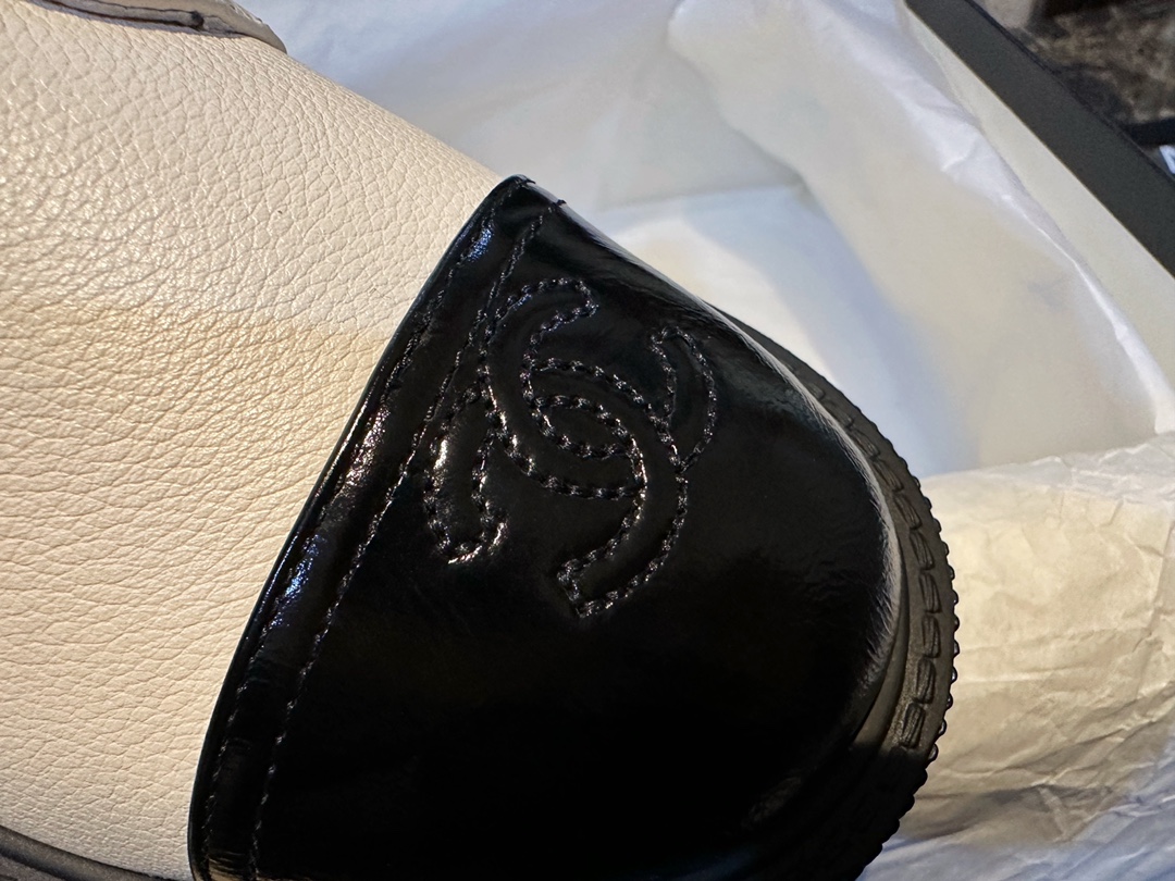 Chanel  23b Chunky Sole Martin Ankle Boots: Featuring a combination of white lychee-patterned cowhide and black oil-wax leather