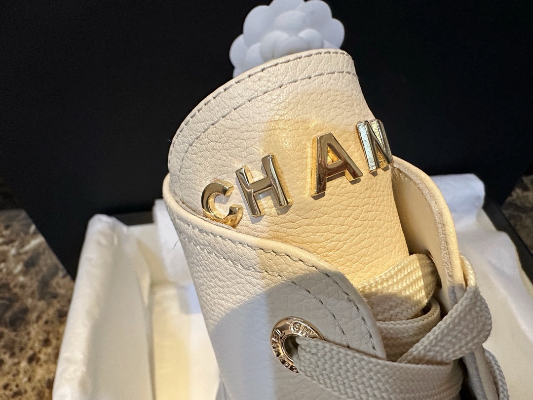 Chanel  23b Chunky Sole Martin Ankle Boots: Featuring a combination of white lychee-patterned cowhide and black oil-wax leather