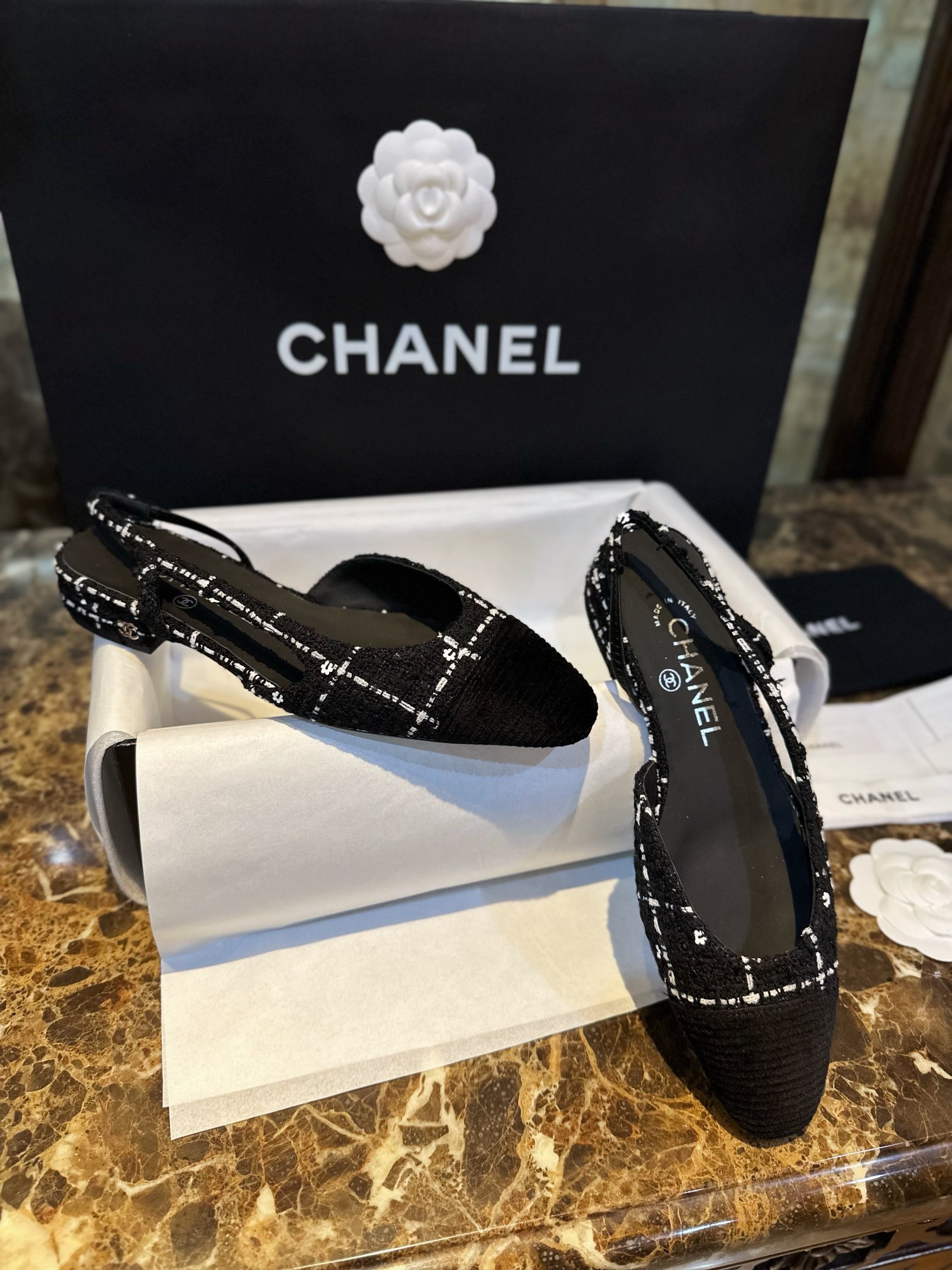 Chanel  Camellia Pattern Flat Shoes with Black and White Grids, Embellished with Sparkling Tweed, Cozy Sheepskin Lining, and Italian Imported Leather Sole.