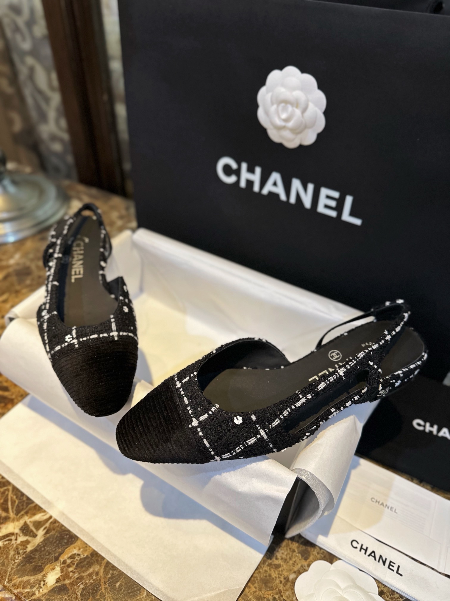 Chanel  Camellia Pattern Flat Shoes with Black and White Grids, Embellished with Sparkling Tweed, Cozy Sheepskin Lining, and Italian Imported Leather Sole.