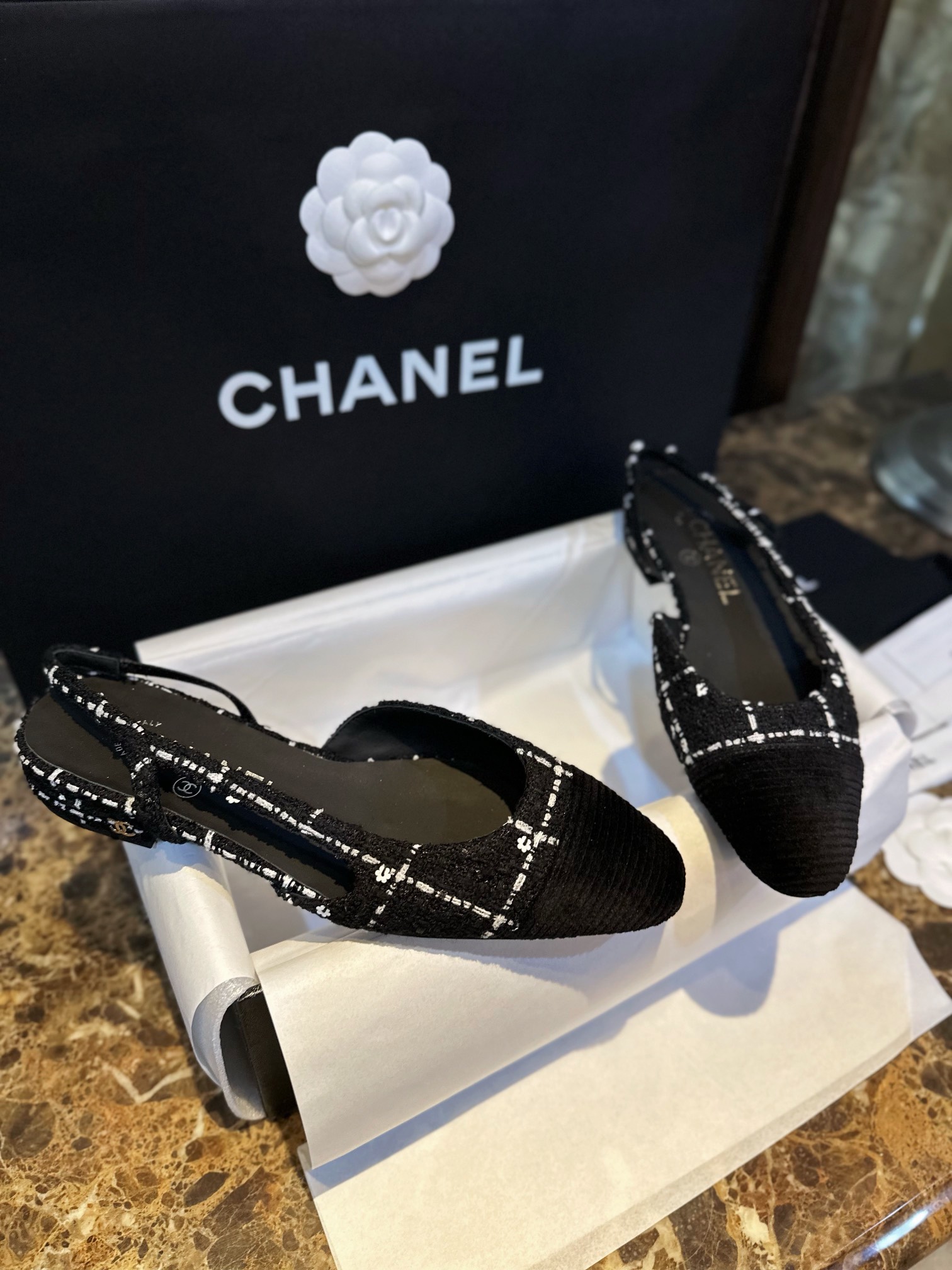 Chanel  Camellia Pattern Flat Shoes with Black and White Grids, Embellished with Sparkling Tweed, Cozy Sheepskin Lining, and Italian Imported Leather Sole.