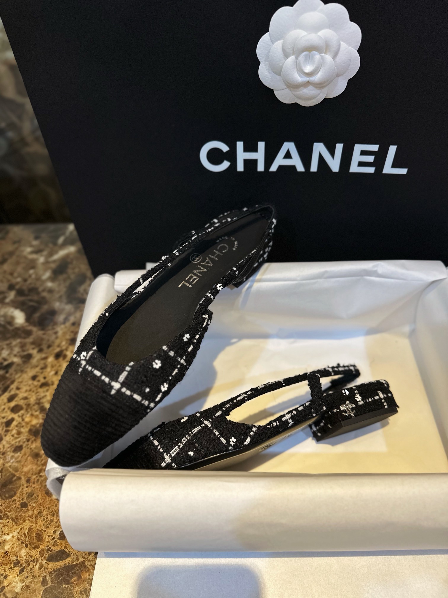 Chanel  Camellia Pattern Flat Shoes with Black and White Grids, Embellished with Sparkling Tweed, Cozy Sheepskin Lining, and Italian Imported Leather Sole.