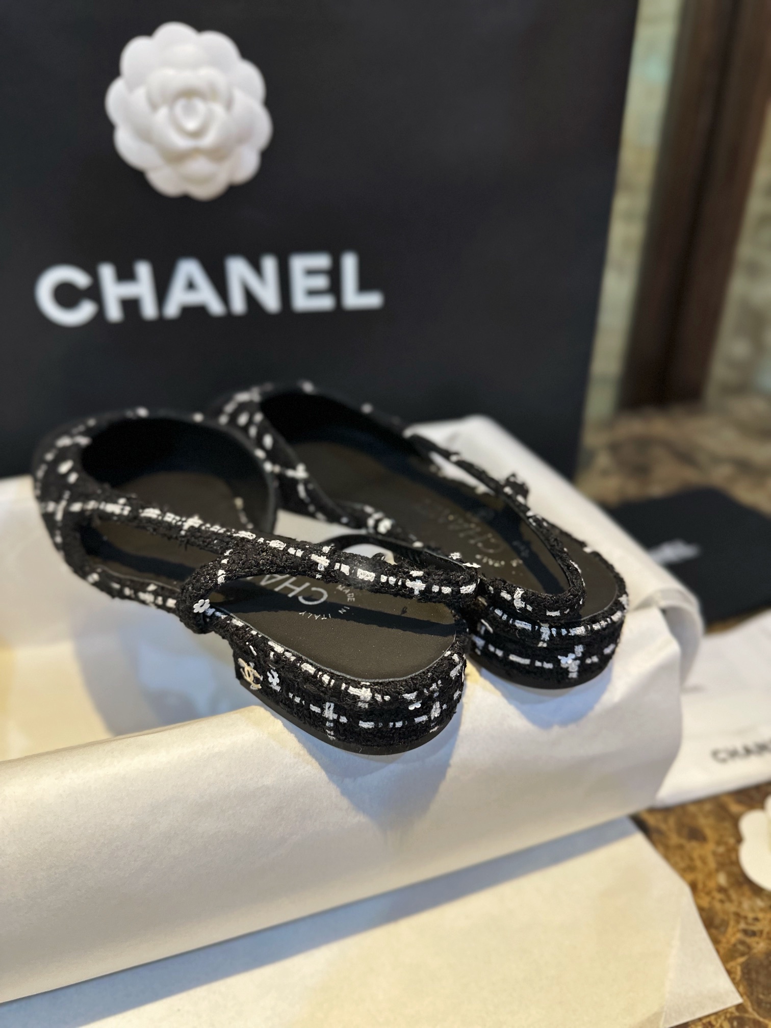 Chanel  Camellia Pattern Flat Shoes with Black and White Grids, Embellished with Sparkling Tweed, Cozy Sheepskin Lining, and Italian Imported Leather Sole.