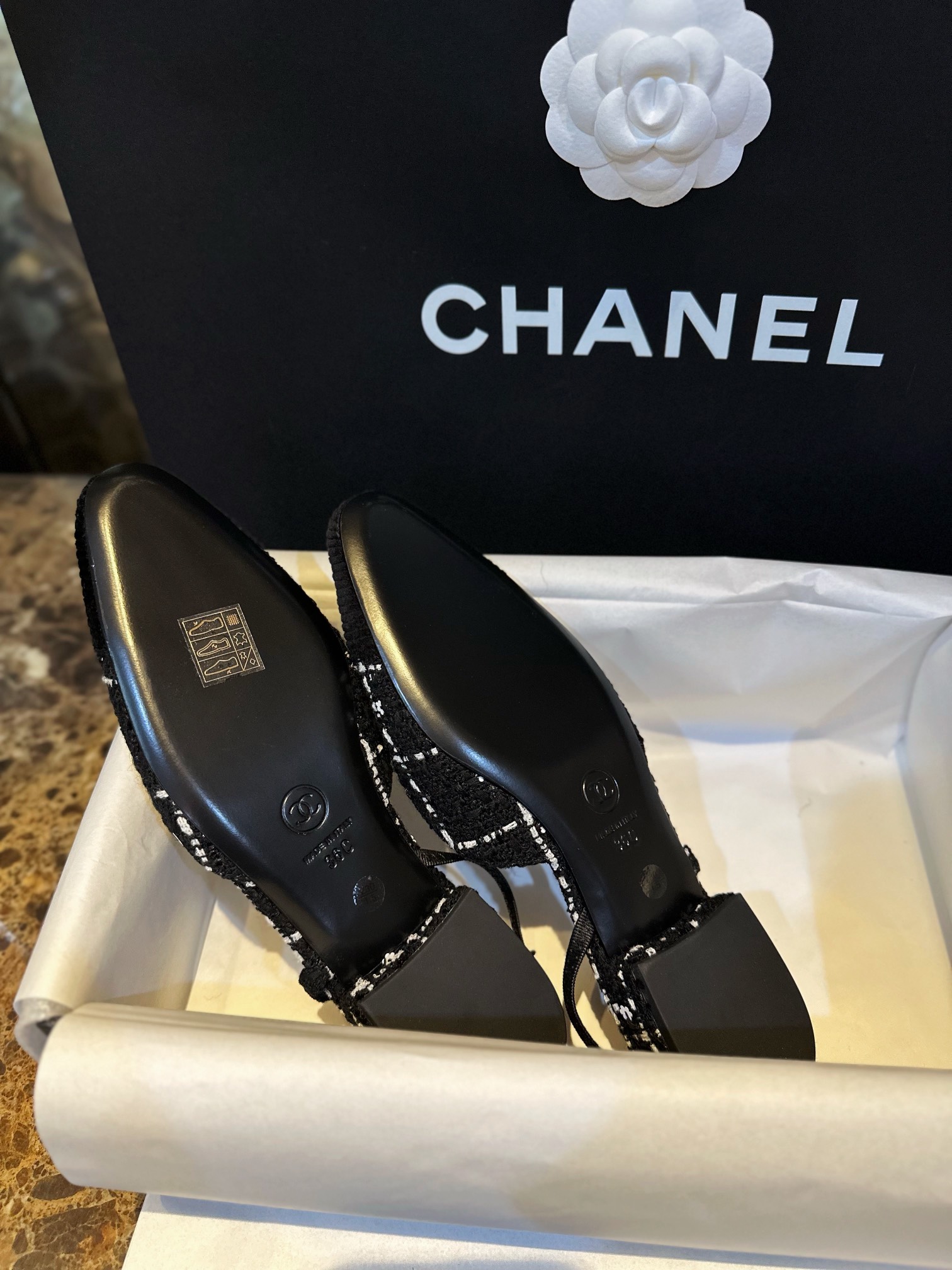 Chanel  Camellia Pattern Flat Shoes with Black and White Grids, Embellished with Sparkling Tweed, Cozy Sheepskin Lining, and Italian Imported Leather Sole.