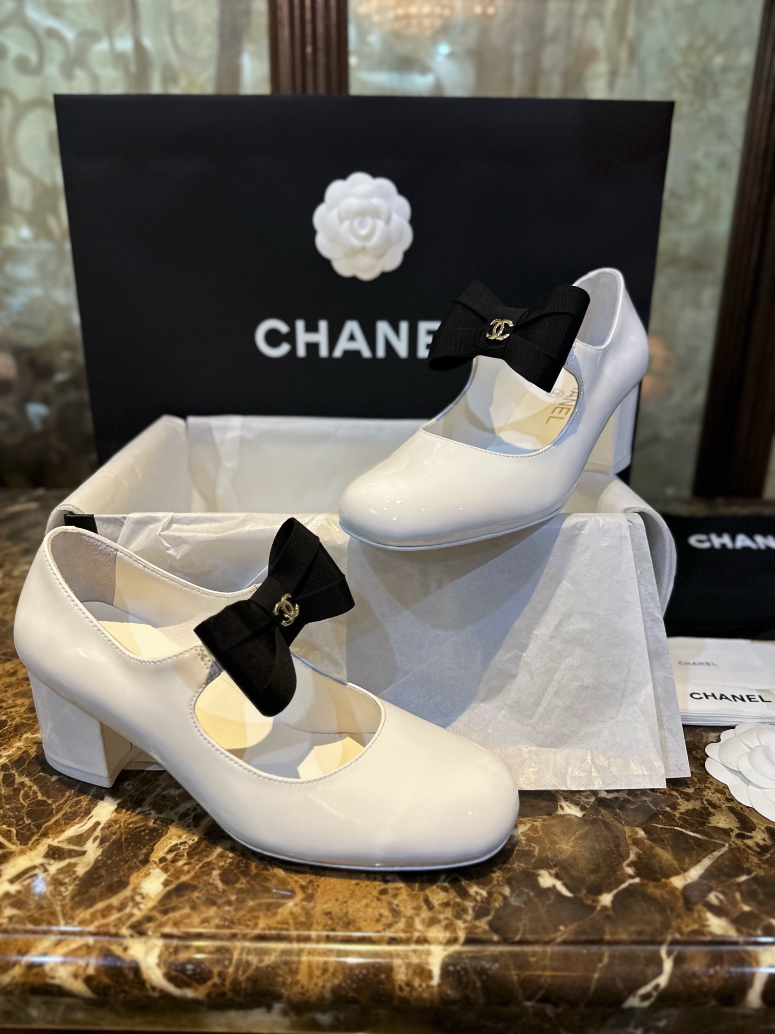 Chanel White Bow High Heel Mary Janes - 3D Bow Detailing Adds Extra Charm, Giving Off an Aura of Aristocratic Elegance, White Patent Leather with Black and White Color Contrast, Embedded Double C Hardware Enhances Design Appeal