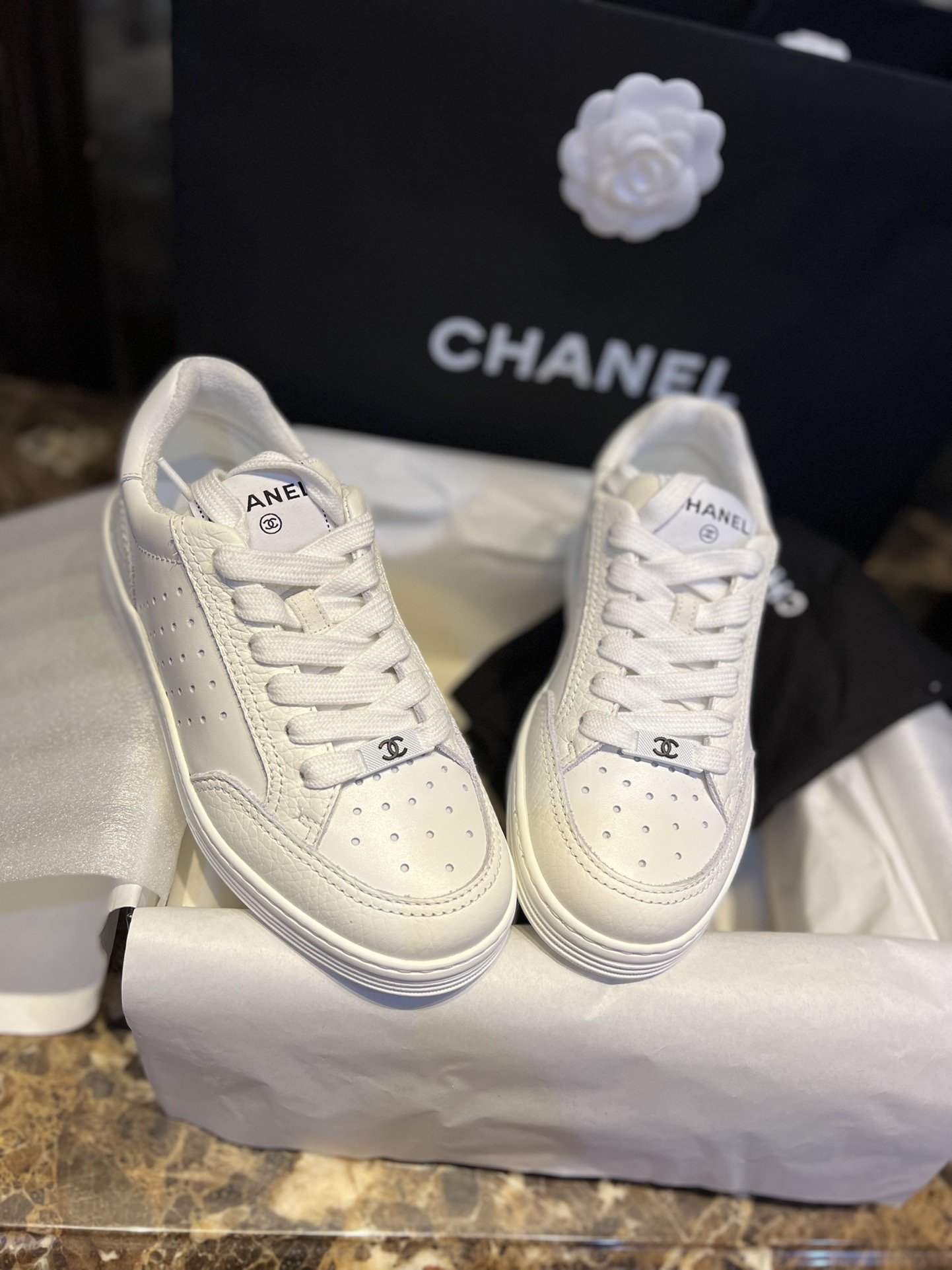 Chanel Embossed White Sneakers