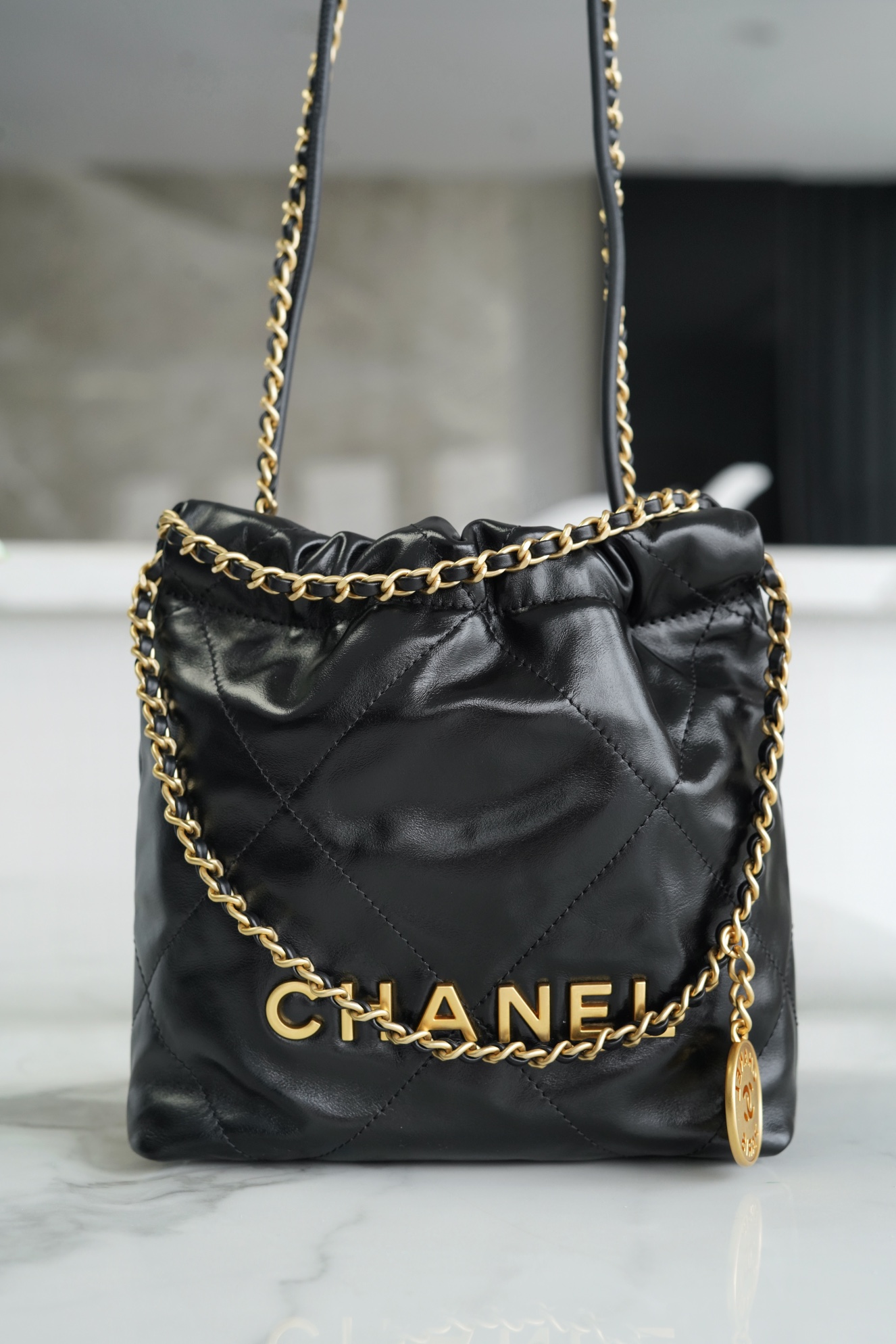 Chanel 23A 22 Mini Bag, Black and Gold, Calfskin